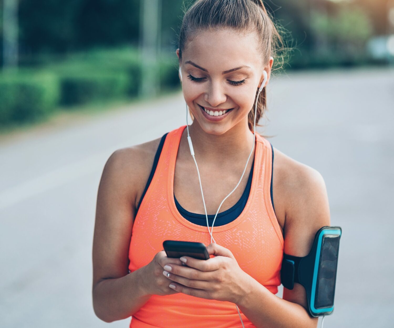 Young jogger interacting with digital health application - mHealth